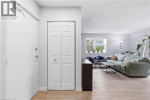 Entryway with bi-fold closet doors and wood-finish flooring extending into the main living area - 91 Westmount Road Unit# 3, Waterloo, ON - Indoor