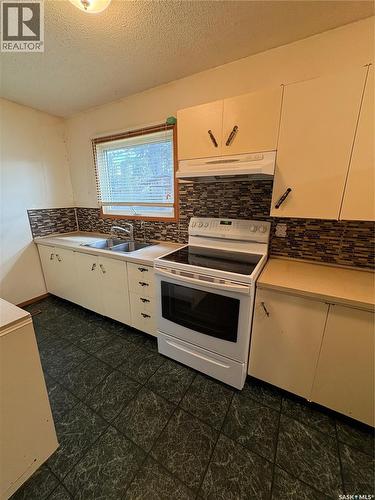 209 2Nd Avenue E, Kelvington, SK - Indoor Photo Showing Kitchen With Double Sink