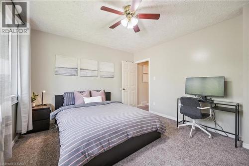 Bedroom featuring a ceiling fan with light fixture, neutral wall paint, and gray carpet flooring - 87 Barbara Crescent, Kitchener, ON - Indoor Photo Showing Bedroom