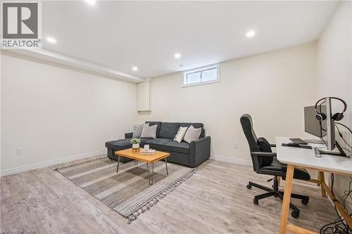 Spacious room featuring wood-finish flooring, recessed lighting, and a white-framed window - 87 Barbara Crescent, Kitchener, ON - Indoor