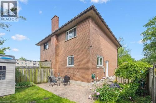 Brick exterior with multiple windows and a large chimney - 87 Barbara Crescent, Kitchener, ON - Outdoor With Exterior