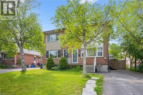 Brick exterior with light-colored siding accents, featuring a front porch with white railing - 87 Barbara Crescent, Kitchener, ON - Outdoor