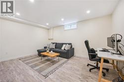 Spacious room featuring wood-finish flooring, recessed lighting, and a white-framed window - 
