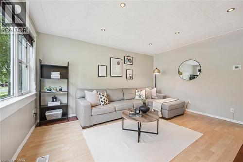 Living area featuring light wood-finish flooring, recessed ceiling lighting, and a large window - 87 Barbara Crescent, Kitchener, ON - Indoor Photo Showing Living Room