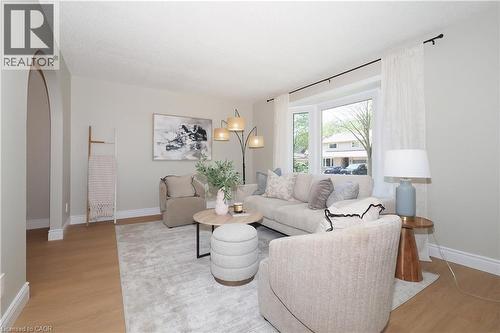 Spacious living area featuring light wood-finish flooring, a contemporary area rug, and a large bay window - 27 Scenic Wood Crescent, Kitchener, ON - Indoor Photo Showing Living Room