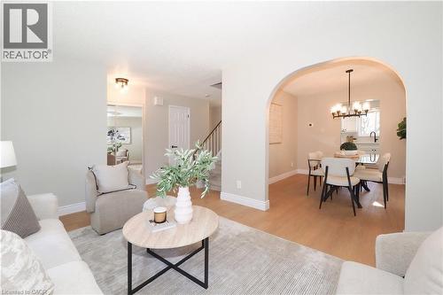 Open-concept living area featuring light wood-finish flooring, recessed lighting, and a broad arched entryway - 27 Scenic Wood Crescent, Kitchener, ON - Indoor Photo Showing Living Room