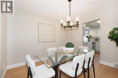 Dining area with light-toned walls and wood-finish flooring - 27 Scenic Wood Crescent, Kitchener, ON - Indoor Photo Showing Dining Room