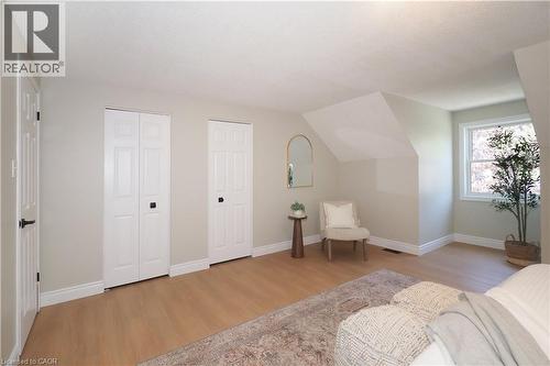 Light wood-finish flooring with white baseboards throughout - 27 Scenic Wood Crescent, Kitchener, ON - Indoor Photo Showing Bedroom