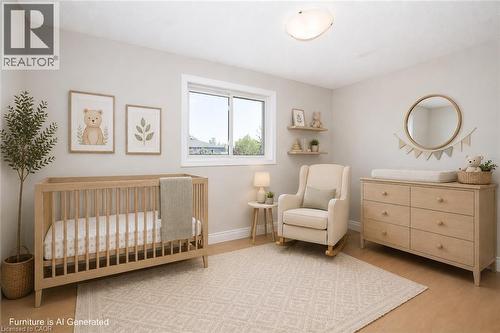 Naturally lit interior space featuring light-colored walls and wood-finish flooring - 27 Scenic Wood Crescent, Kitchener, ON - Indoor Photo Showing Bedroom