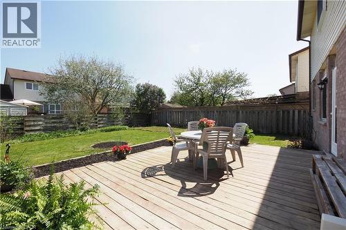 Expansive backyard featuring a wood deck and manicured lawn - 27 Scenic Wood Crescent, Kitchener, ON - Outdoor With Deck Patio Veranda