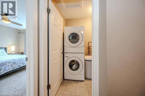 Dedicated laundry area featuring a stacked washer and dryer unit - 275 Old Huron Road Unit# 21, Kitchener, ON - Indoor Photo Showing Laundry Room