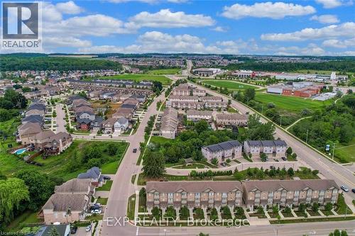 Expansive aerial showcasing a residential neighborhood with a mix of detached homes and townhouses - 275 Old Huron Road Unit# 21, Kitchener, ON - Outdoor With View