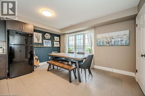 Dining area featuring a large window, tiled flooring, and a built-in wall shelf - 275 Old Huron Road Unit# 21, Kitchener, ON - Indoor Photo Showing Dining Room