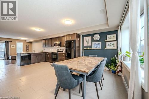Open-concept kitchen and dining area with light-toned tile flooring - 275 Old Huron Road Unit# 21, Kitchener, ON - Indoor