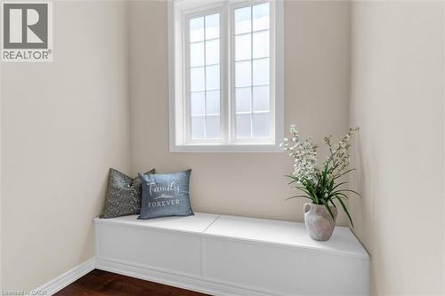 Stair landing area features a built-in storage bench and a large window - 16 Westridge Drive, Hamilton, ON - Indoor Photo Showing Other Room
