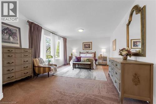 Spacious primary room (26'9"" x 12'11"") featuring upgraded stain-resistant carpeting (2019) and multiple large windows and a walk-in closet - 16 Westridge Drive, Hamilton, ON - Indoor Photo Showing Bedroom