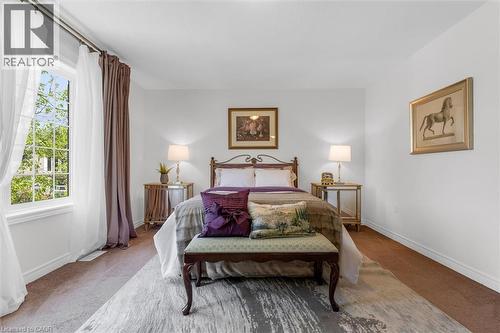 Spacious primary room (26'9"" x 12'11"") featuring upgraded stain-resistant carpeting (2019) and multiple large windows and a walk-in closet - 16 Westridge Drive, Hamilton, ON - Indoor Photo Showing Bedroom