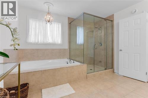 Primary bathroom featuring a tiled soaking tub and a glass-enclosed shower - 16 Westridge Drive, Hamilton, ON - Indoor Photo Showing Bathroom
