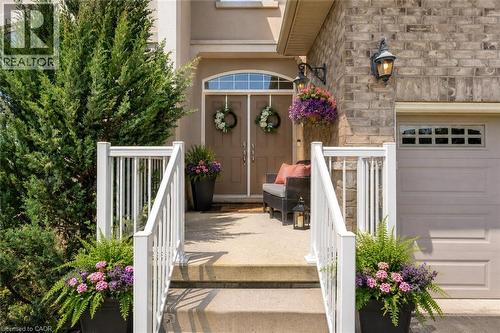Front entry with concrete porch,  stone and stucco facade, a double door entry - 16 Westridge Drive, Hamilton, ON - Outdoor