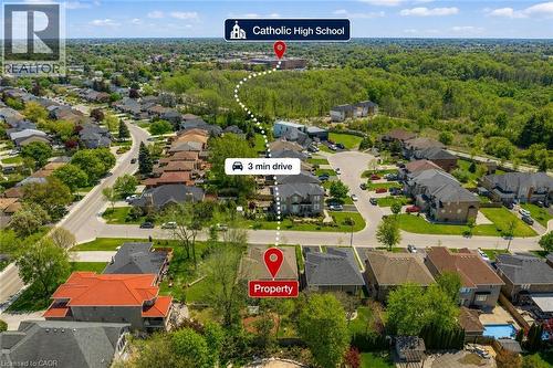 Aerial perspective showcasing a residential development bordered by extensive green spaces, situated on a quiet court street, short distance to St. Thomas More Catholic High School. - 16 Westridge Drive, Hamilton, ON - Outdoor With View
