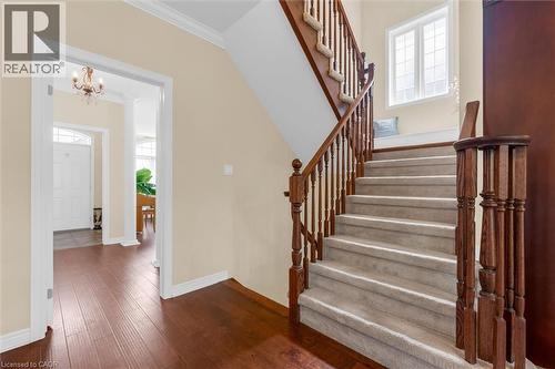 Grand red oak staircase featuring wood balusters and stain-resistant carpet (2019) - 16 Westridge Drive, Hamilton, ON - Indoor Photo Showing Other Room
