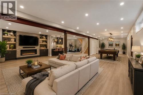 potential for basement finishing (virtual staged/designed) - 16 Westridge Drive, Hamilton, ON - Indoor Photo Showing Living Room With Fireplace