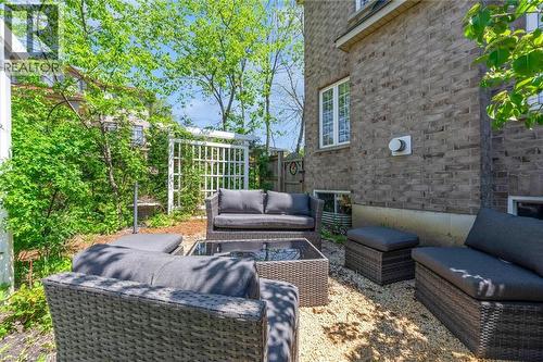 Private exterior space featuring a gravel patio area with mature trees and a white lattice trellis - 16 Westridge Drive, Hamilton, ON - Outdoor With Deck Patio Veranda