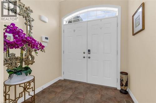 Double entry doors with an arched transom window and tiled floor - 16 Westridge Drive, Hamilton, ON - Indoor Photo Showing Other Room