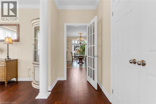 Rich anti-slippery engineered flooring extending through an open archway with decorative columns - 16 Westridge Drive, Hamilton, ON - Indoor Photo Showing Other Room