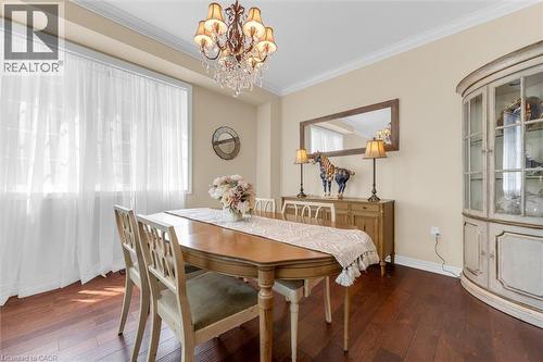 Formal dining space featuring wood-finish flooring, a large window and crown molding - 16 Westridge Drive, Hamilton, ON - Indoor Photo Showing Dining Room