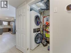 Dedicated laundry closet featuring a stacked washer and dryer unit - 