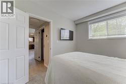 Bright room with light gray walls and a window featuring white blinds - 