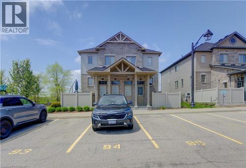 Stone and siding facade featuring a gabled roofline and covered entryway - 388 Old Huron Road Unit# 24A, Kitchener, ON - Outdoor With Facade