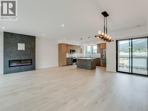 Dining, kitchen, living room all open concept - 910 Lakeside Drive Unit# 208, Nelson, BC - Indoor With Fireplace