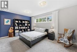 Carpeted room featuring a wide window, built-in shelving, and recessed lighting - 