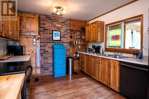 Kitchen w/pass throughwindow to Dining area - 294 Everett Drive, Parry Sound Remote Area (Restoule), ON - Indoor Photo Showing Kitchen With Fireplace With Double Sink
