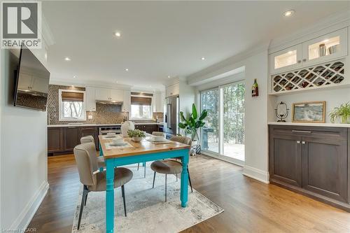 Dining area with crown molding, light wood-style flooring, and recessed lighting - 3311 Springvale Court, Burlington, ON - Indoor Photo Showing Dining Room