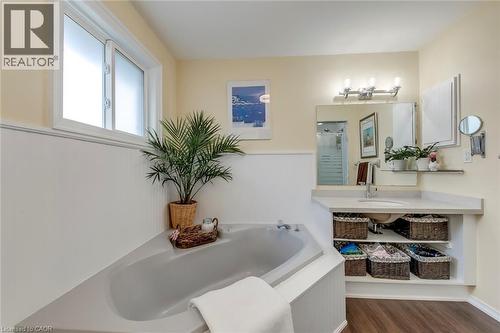 Full bath featuring vanity, a bath, dark wood-style floors, and a shower stall - 3311 Springvale Court, Burlington, ON - Indoor Photo Showing Bathroom
