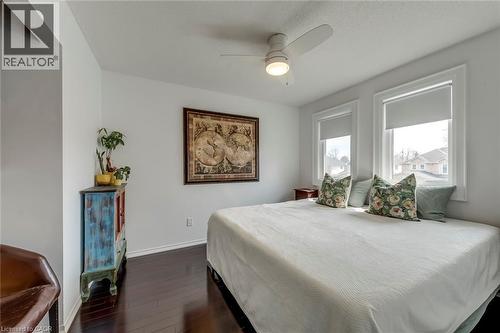 Bedroom with dark wood-style floors and ceiling fan - 3311 Springvale Court, Burlington, ON - Indoor Photo Showing Bedroom