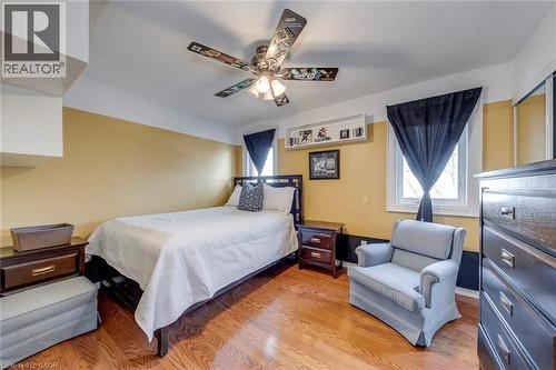 Bedroom featuring multiple windows, light wood-style floors, and ceiling fan - 3311 Springvale Court, Burlington, ON - Indoor Photo Showing Bedroom