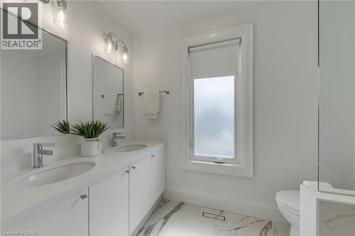 Bathroom featuring double vanity and light marble finish floors - 3311 Springvale Court, Burlington, ON - Indoor Photo Showing Bathroom