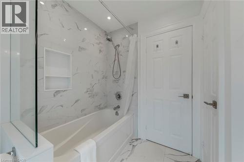 Bathroom with light marble finish floors, shower / bath combination with curtain, and recessed lighting - 3311 Springvale Court, Burlington, ON - Indoor Photo Showing Bathroom