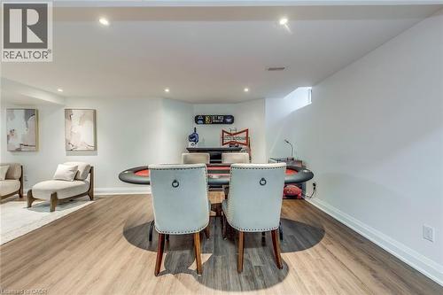 This versatile space features light-toned walls, recessed lighting, and durable wood-look flooring - 3311 Springvale Court, Burlington, ON - Indoor