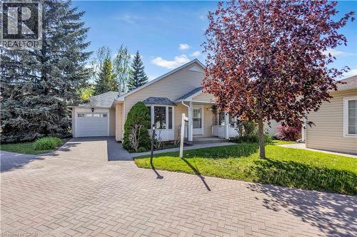 Exterior featuring light-colored siding, a prominent bay window, and an attached single-car garage - 375 Silverbirch Boulevard, Hamilton, ON - Outdoor With Facade
