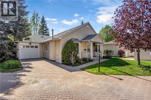 Single-story residence featuring light-toned horizontal siding and a gray shingled roof - 375 Silverbirch Boulevard, Hamilton, ON - Outdoor With Facade