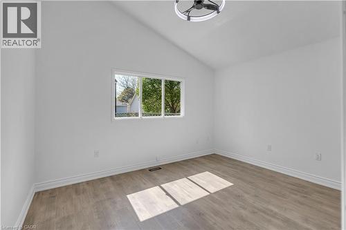 Vaulted ceiling room featuring white walls, light wood-finish flooring, and a modern ceiling fan with integrated lighting - 375 Silverbirch Boulevard, Hamilton, ON - Indoor Photo Showing Other Room