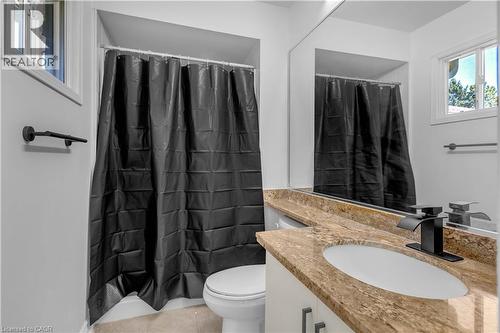 Bathroom with a vanity featuring a light granite countertop, an undermount sink, and a matte black faucet - 375 Silverbirch Boulevard, Hamilton, ON - Indoor Photo Showing Bathroom