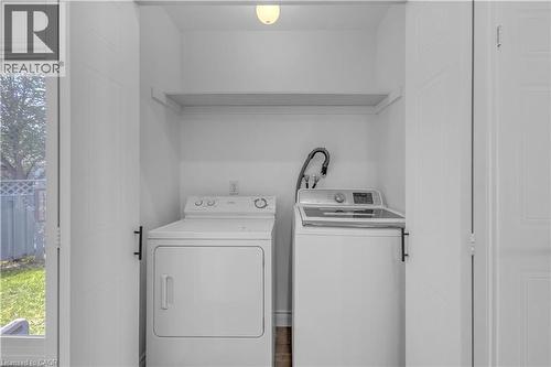 Dedicated laundry area featuring a shelf, overhead lighting, and white bi-fold doors - 375 Silverbirch Boulevard, Hamilton, ON - Indoor Photo Showing Laundry Room