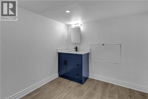 Modern vanity with a blue finish, white countertop, and black hardware - 375 Silverbirch Boulevard, Hamilton, ON - Indoor Photo Showing Other Room