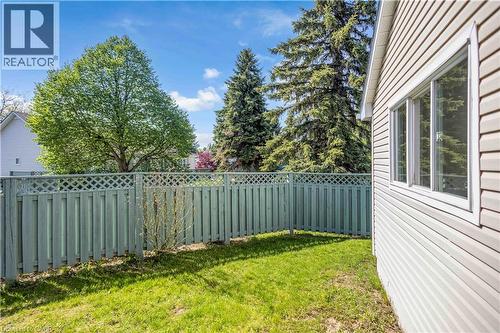 Exterior siding with multiple windows, featuring a private fenced yard with established trees and green space - 375 Silverbirch Boulevard, Hamilton, ON - Outdoor
